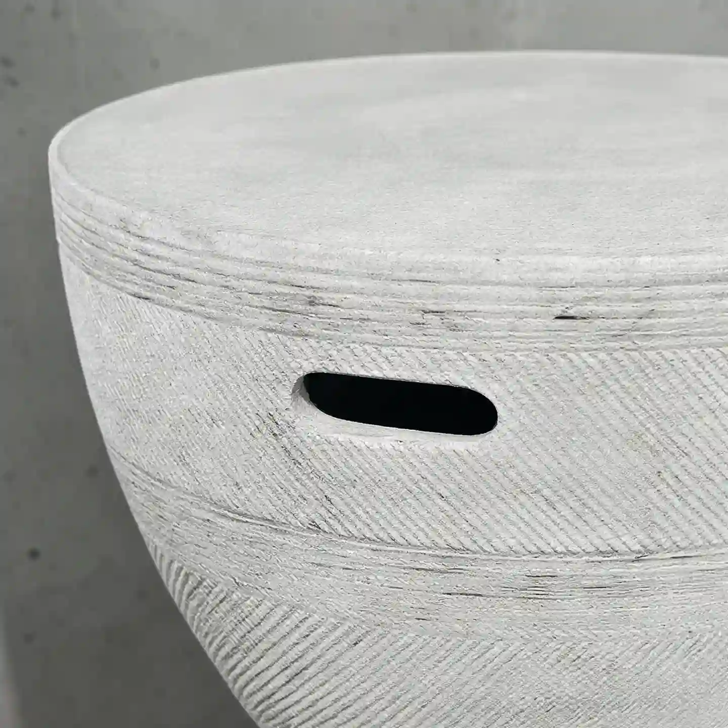 Close-up view of an embossed cross-hatch cement facade featuring a smooth handling void. Showcasing structural engineering and tooling clarity for industrial design procurement.